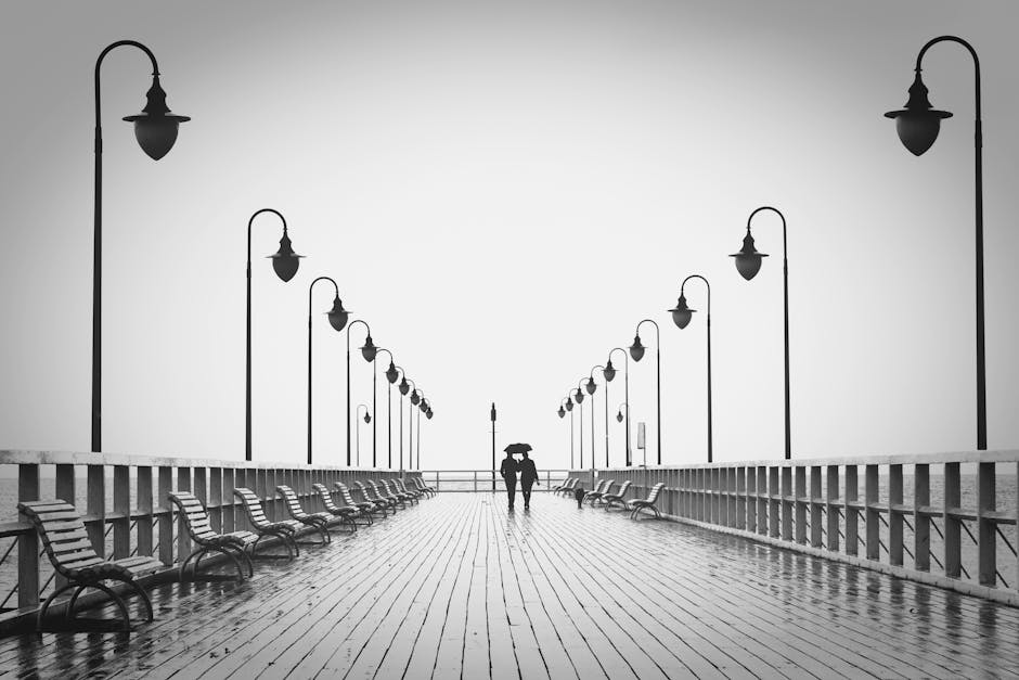 Two People Walking on Pier